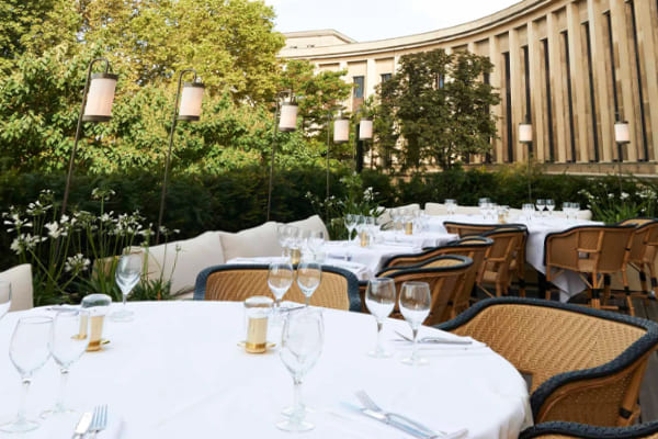 Outdoor seating at Girafe Paris with a view of the Eiffel Tower